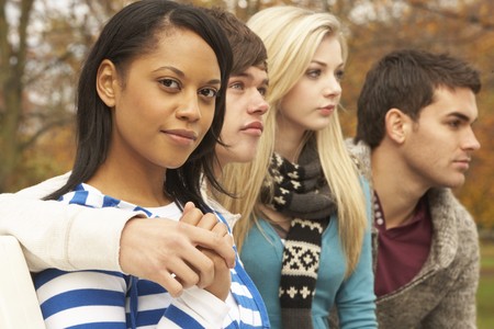 Close Up Of Group Of Four Teenage Friends In Autumn Woodlandの写真素材