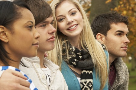 Close Up Of Group Of Four Teenage Friends In Autumn Woodlandの写真素材