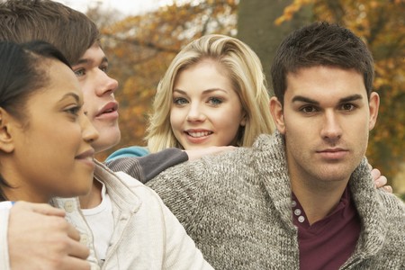 Close Up Of Group Of Four Teenage Friends In Autumn Woodlandの写真素材