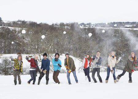 Group Of Teenage Friends Having Fun In Snowy Landscapeの写真素材