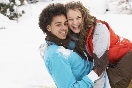 Romantic Teenage Couple Having Fun In Snowの写真素材