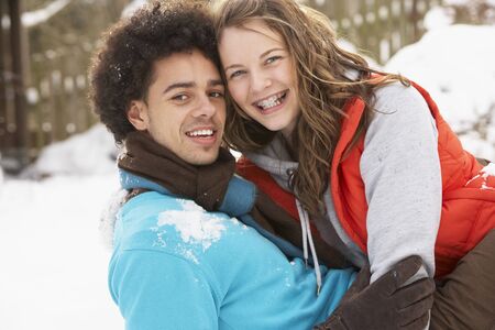 Romantic Teenage Couple Having Fun In Snowの写真素材