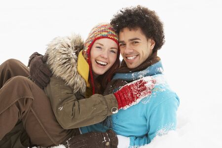 Romantic Teenage Couple Having Fun In Snowの写真素材
