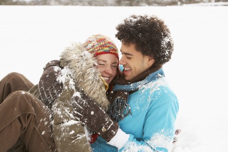 Romantic Teenage Couple Having Fun In Snowの写真素材