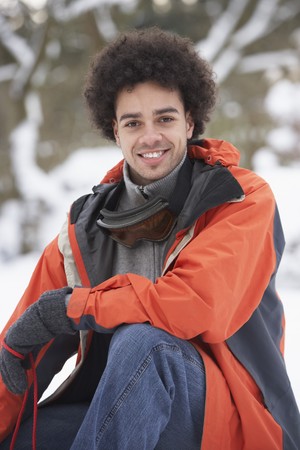 Man Wearing Winter Clothes In Snowy Landscapeの写真素材