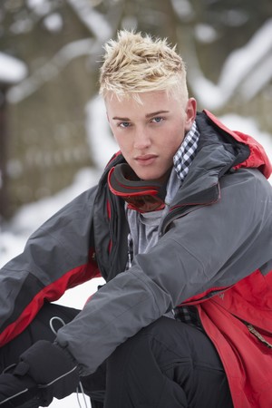 Teenage Boy Wearing Winter Clothes In Snowy Landscapeの写真素材