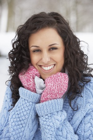 Woman In Snowy Landscape Wearing Warm Clothingの写真素材