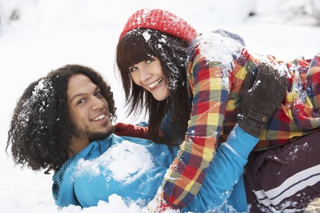 Romantic Teenage Couple Having Fun In Snowの写真素材