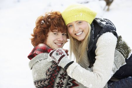Romantic Teenage Couple Having Fun In Snowの写真素材