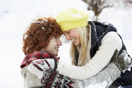 Romantic Teenage Couple Having Fun In Snowの写真素材