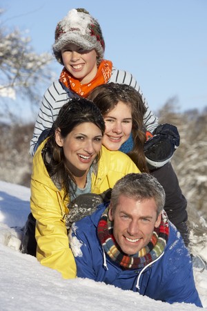 Young Family Having Fun In Snowy Landscapeの写真素材