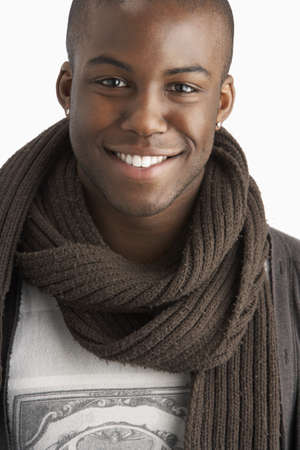 Young Man Wearing Warm Winter Clothing In Studioの写真素材