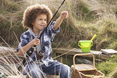 Young Boy Fishing At Seasideの写真素材