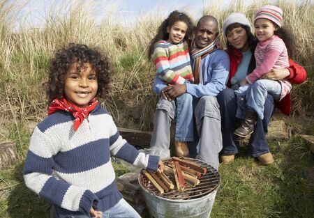 Family Having Barbeque On Winter Beachの写真素材