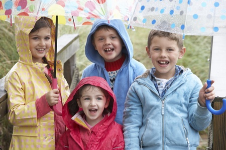 Children posing with umbrellaの写真素材
