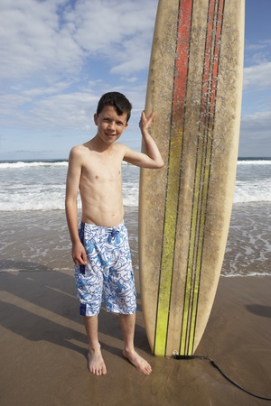 Teenage boy with surfboardの写真素材