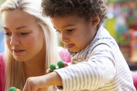 Young woman playing with boyの写真素材