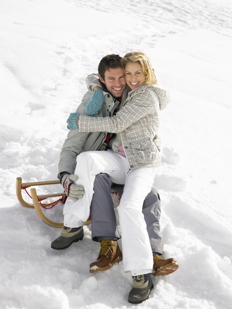 Young Couple On A Sledの写真素材