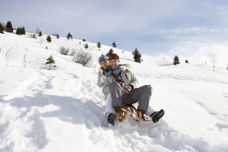 Young Couple Sledding