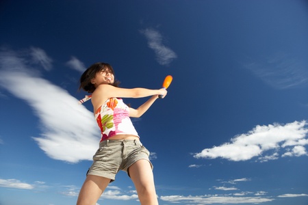 Teenage girl playing baseball on beachの写真素材