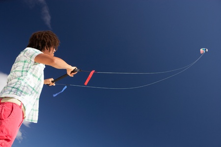 Teenage boy flying a kiteの写真素材