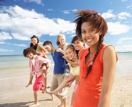 Teenagers walking on beachの写真素材