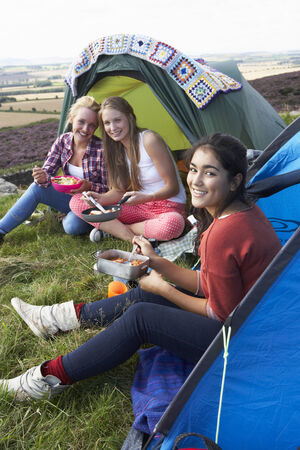 Group Of Teenage Girls On Camping Trip In Countrysideの写真素材
