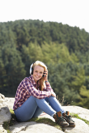 Teenage Girl Listening To Music In Countrysideの写真素材