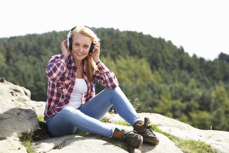 Teenage Girl Listening To Music In Countrysideの写真素材