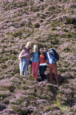 Group Of Young People Hiking Through Countrysideの写真素材