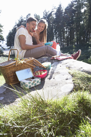 Young Couple Enjoying Picnic In Countrysideの写真素材