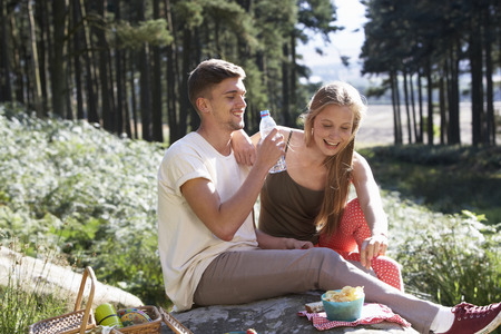 Young Couple Enjoying Picnic In Countrysideの写真素材