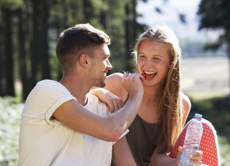 Young Couple Enjoying Picnic In Countrysideの写真素材