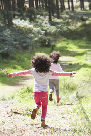 Two Girls Playing In Woods Togetherの写真素材