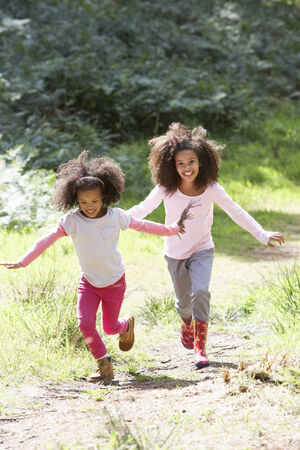 Two Girls Playing In Woods Togetherの写真素材