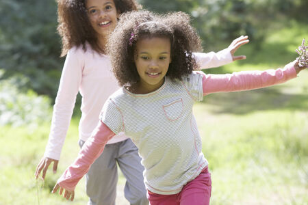 Two Girls Playing In Woods Togetherの写真素材