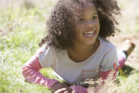 Girl Lying On Grass In Countrysideの写真素材