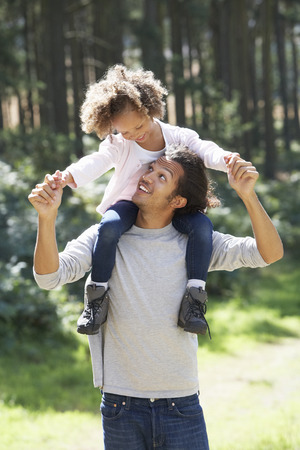 Father Giving Daughter Ride On Shoulders In Countrysideの写真素材