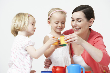 Pre School Children Enjoying Tea Party With Teacherの写真素材