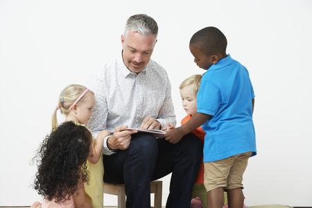 Pre School Teacher Reading Story To Childrenの写真素材