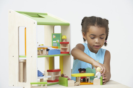 Pre-School Pupil Playing With Wooden Houseの写真素材