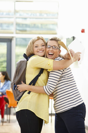 Teacher Congratulating Pupil On Successful Exam Resultの写真素材