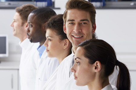 Portrait Of Technician In Laboratory With Colleaguesの写真素材