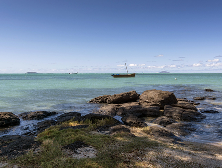 Mauritian traditional boat floating in Turquoise Oceanの写真素材