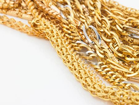 Lots of gold chains on white backgroundの写真素材