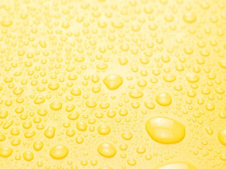 water drops on yellow backgroundの写真素材