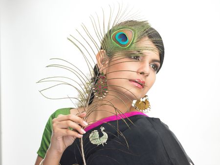  Teenage girl with peacock feathersの写真素材