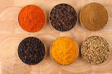   bowls of spicy ingredients on wooden tray
