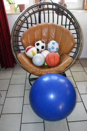 bright composition with little balls and big blue medicine ballの写真素材