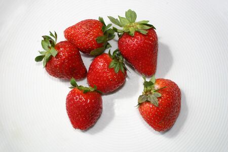 Six isolated strawberries on white backgroundの写真素材